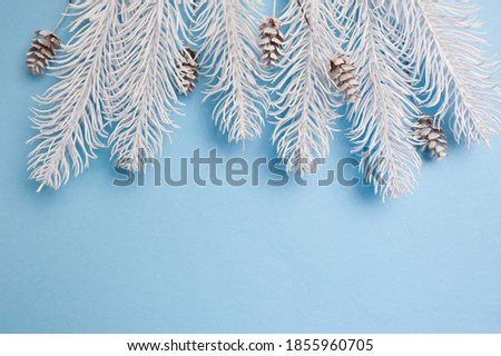 Merry Christmas and Happy New Year greeting card branches frame or banner. Fir tree on blue background top view. Winter holiday theme