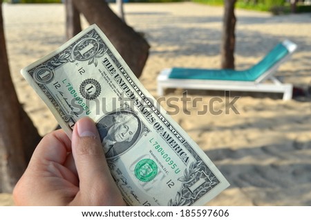 a dollar in business man's hand on holiday