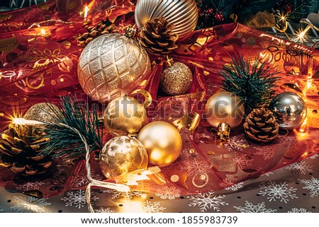 Christmas decoration red ribbons, golden balls, light, cones, pine.