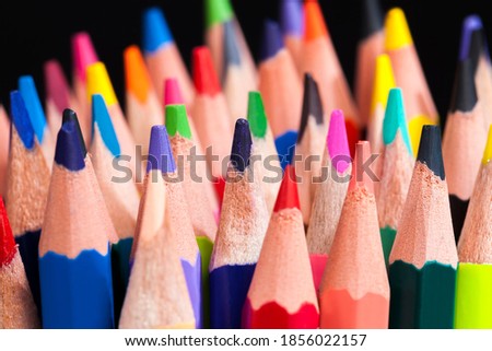 ordinary colored wooden pencil with soft lead of different colors for drawing and creativity, close-up of pencils after sharpening and using, pencil made of natural materials safe for children