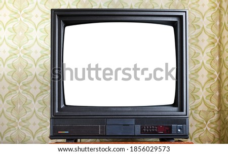 Antique TV with white screen on antique wooden cabinet, vintage design in 80s and 90s style house. Royalty-Free Stock Photo #1856029573