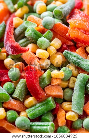 Various frozen vegetables close-up. Frozen corn, peas, carrots, and peppers.
