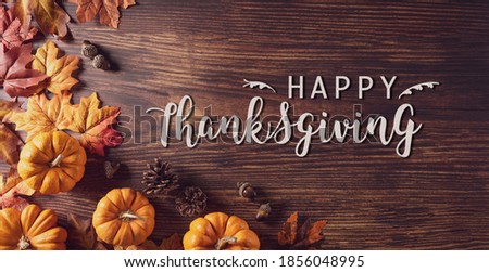 Thanksgiving background decoration from dry leaves and pumpkin on old wooden background. Flat lay, top view for Autumn, fall, Thanksgiving concept.