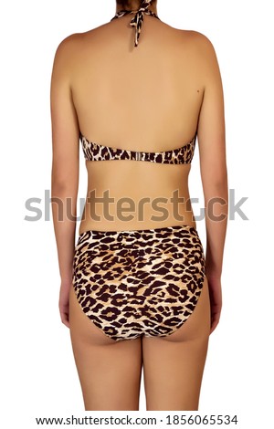 Female body back profile in brown leopard print bikini against white background
