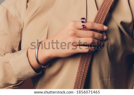 close up of boho styled woman hands with silver jewelry.