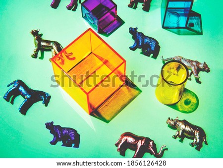 Various animal toy figures with boxes and in a colorful background