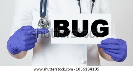 Medicine and health concept. The doctor points his finger at a sign that says - BUG