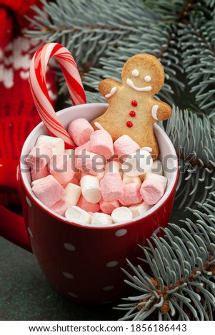 Christmas greeting card with fir tree and cacao cup with marshmallow, candy cane and gingerbread man