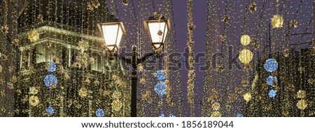 Famous pedestrian touristic Nikolskaya street had been  decorated to New year holidays during coronavirus pandemic time. View at the sky, festive decoration in night.  