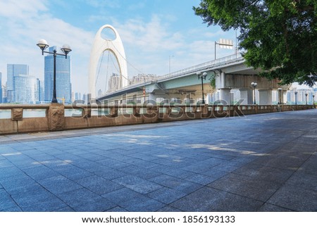 Streets and cable stayed bridges and skylines of modern urban buildings along the Pearl River in Guangzhou City, Guangdong Province, China