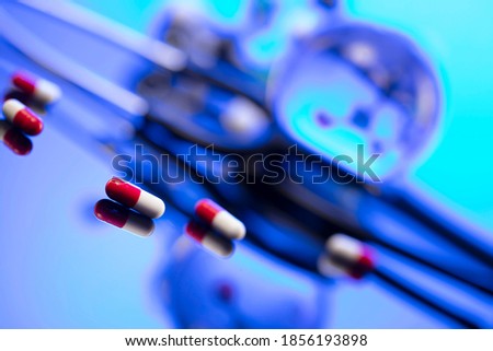 Medical concept. Stethoscope and medicaments on blue background.