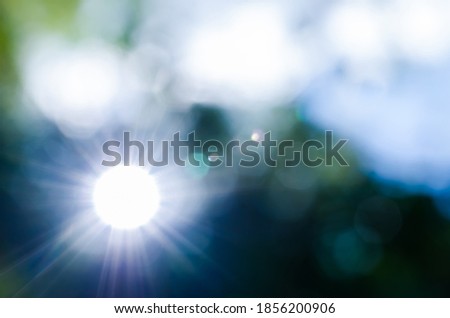 Blur background, the sun looks unusual and has colorful bokeh.