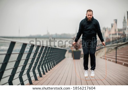 A healthy young man enjoying an outdoor workout on a cold day