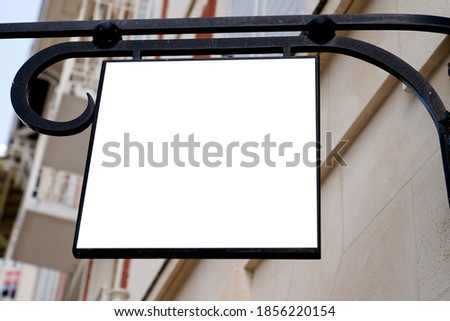 Blank mock up of rectangular logo sign in front of a shop wall