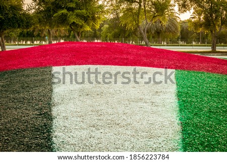 A United Arab Emiratees Flag images against clean and tranquil sky . UAE celebrates national day on 2nd December every year.