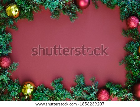 Festive background with copy space for text. Christmas border of fir branches and holly berries. Flat lay, top view. High quality photo
