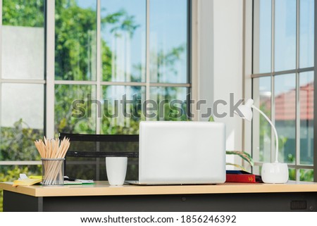 Back laptop computer putting on working desk, Workplace with notebook laptop on the table, Home interior or office background