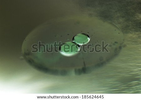 Abstract composition of oil drops on a water surface with very soft focus