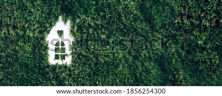 Eco house concept. Top view. White house model on green grass, forest moss background. Top view. Copy space. Eco friendly house. Zero waste, organic, sustainable lifestyle. Trendy eco home in nature.