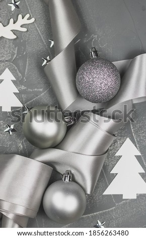 Silver christmas postcard with white scandi and silver christmas toys, silver ribbon ans stars. Minimalistic mock up for congratulation.
