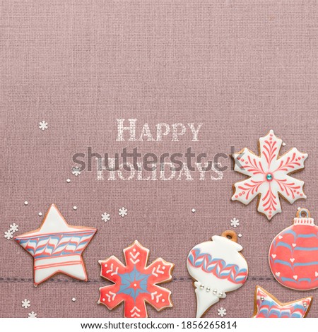 Happy Holidays text and handmade traditional gingerbread cookies greeting card. Simple, retro Christmas flat lay template
