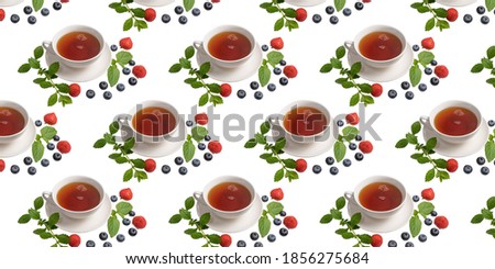 A Cup of tea, strawberries, blueberries and mint leaves on a white isolated background. Seamless pattern. Original packaging design