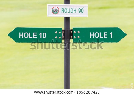 Signs for the tee off at the golf course, hole 1 and hole 10 with flower nature background