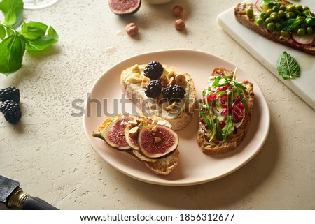 Top view of various bruschettas with toppings. Snack finger food meal, starter or delicious breakfast toast