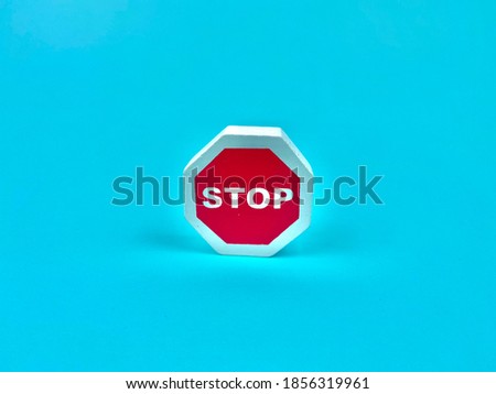 The red sign has the word STOP inside a blue background.