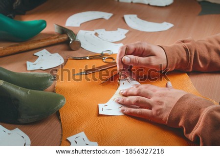 Close up of shoemaker at work on the table
