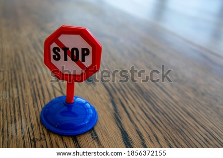 Isolated plastic toy warning sign - STOP. Danger ahead, do not enter, forbidden, construction sight, road sign, signpost concept background. Isolated with space for copy text.