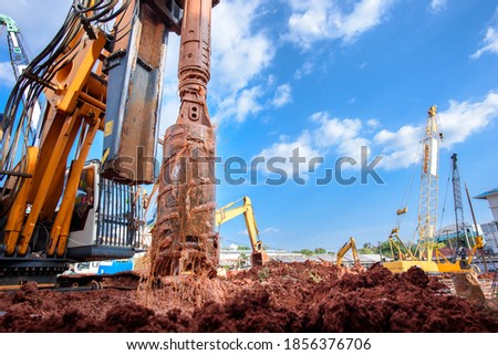 Earth drilling machine or hydraulic boring machine into a construction site for drilling piles. Royalty-Free Stock Photo #1856376706