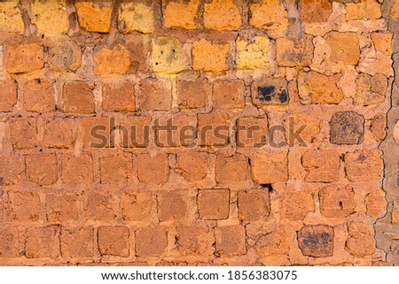 Peeled brick wall, clay brick and old texture
