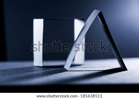 Dark blue paper shapes and shadows with paper background 