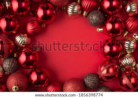 Christmas is coming concept. Top above overhead view close up photo of beautifully decorated red baubles frame isolated on red background with copyspace in center