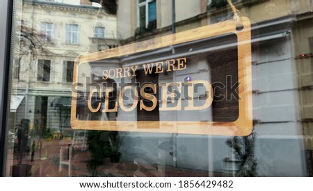 Temporarily closed sign for Covid-19 in small business activity. Close up on closed placard in the window of a shop for coronavirus. Royalty-Free Stock Photo #1856429482