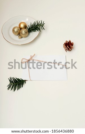 flat lay of envelope and christmas balls and plate with copy space