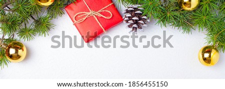 New Year's banner, red gift golden balls spruce bump and twigs. High quality photo Royalty-Free Stock Photo #1856455150