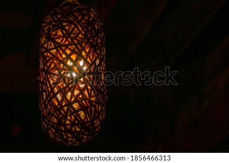 A lamp with warm white lighting made of bamboo.