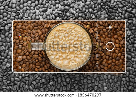 A picture of "kopi tarik" with coffee beans in smartphone frame.