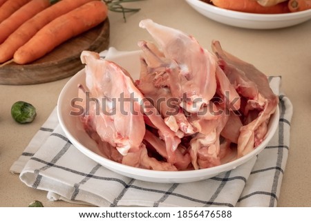 Fresh chicken skeletons and vegetables - ingredients to prepare bone broth
