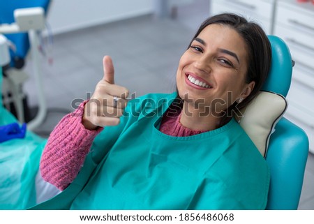 Happy woman patient showing thumb up after successful job.