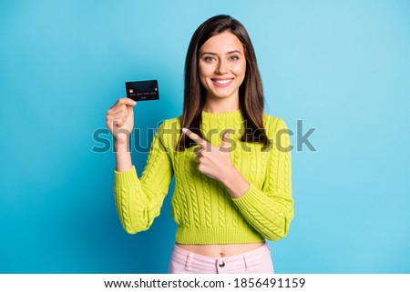 Photo of young attractive girl show point index finger bank card advert choice recommend isolated over blue color background