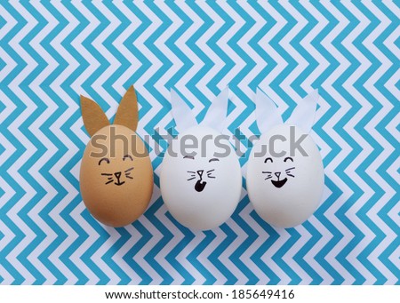Three Easter bunny eggs on a chevron background