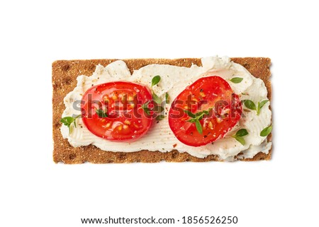 Crispbread with cream cheese and tomato slices on white Royalty-Free Stock Photo #1856526250