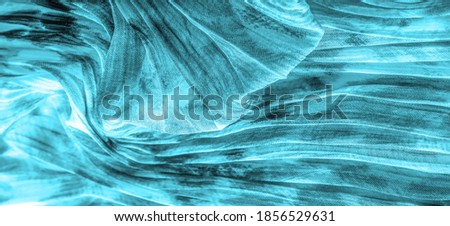 Blue fabric. Silk fabric in fine organza with panther print, Crumpled texture. Background. Template.