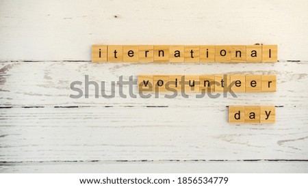 International Volunteer Day.words from wooden cubes with letters photo