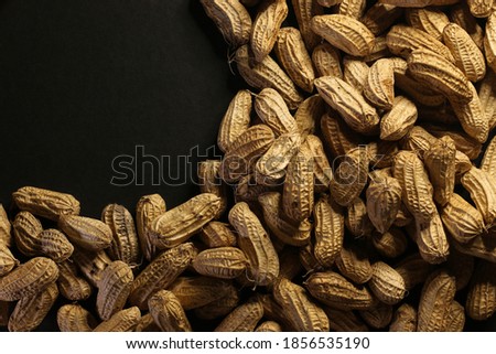Locally grown small highland legumes and peanuts freshly harvested in dark and black matte background