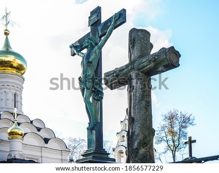 Jesus hanging on the cross in a statue. Inri sculpture against blue  cloudy sky. Orthodox Church.  Moscow, Russia. Donskoy monastery