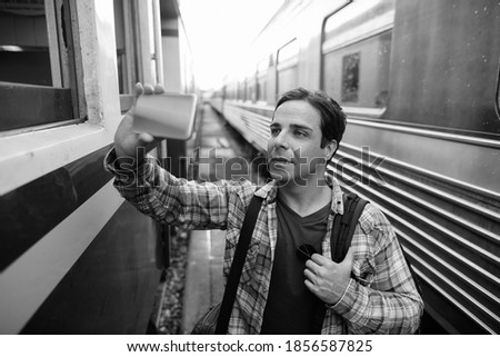 Portrait of handsome Persian tourist man at the railway station